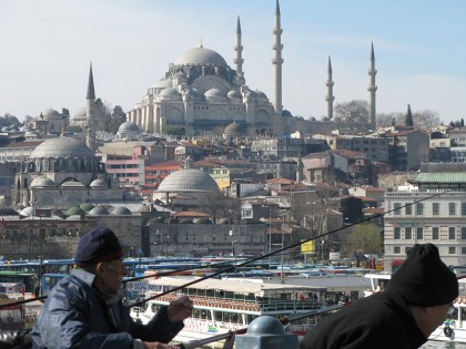 Fishing on the Galata bridge with a mosque in the background